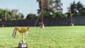 Zelta trofeja uz zaļa golfa laukuma zālāja, gatava Ryder Cup sacensībām.